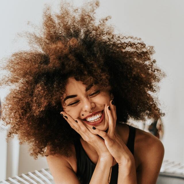 Woman Sitting And Smiling